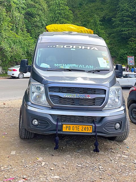 SODHA-branded van parked beside a road through a pine forest