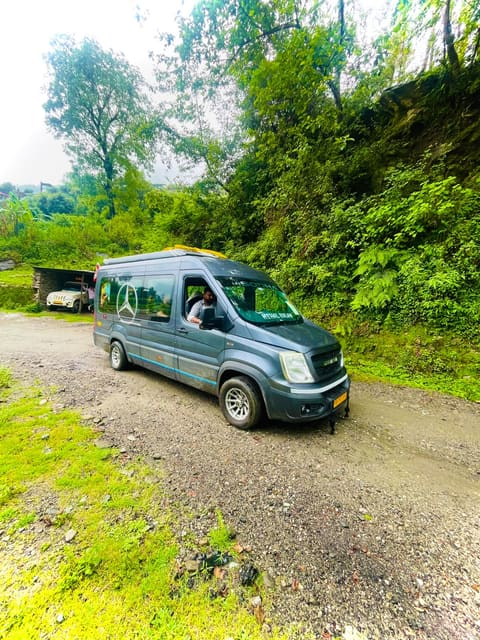 SODHA-branded van on a gravel road between green, wooded hillsides