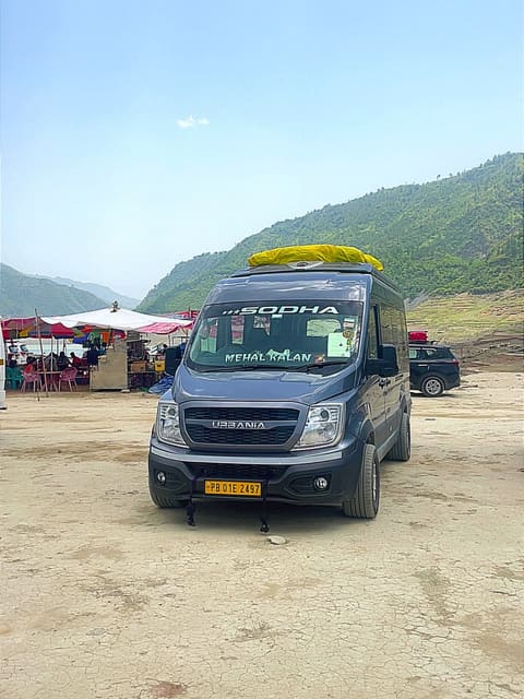 SODHA-branded van parked on open ground in a green hill valley