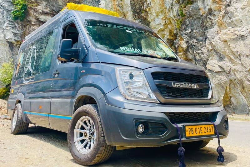 Grey Force Urbania van with SODHA branding, parked beside a rock face on a mountain road